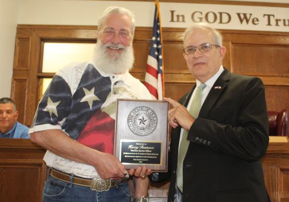 Retiring Van Zandt County Veterans Service Officer Harry Fontenot (left) was honored for his 15 years of service to VZC during the regular meeting of the VZC Commissioners Court June 4. Presenting a plaque to Fontenot is VZC Judge Andy Reese. A retirement reception for Fontenot was held in the basement of the courthouse following the commissioners’ court meeting. Photo by David Barber