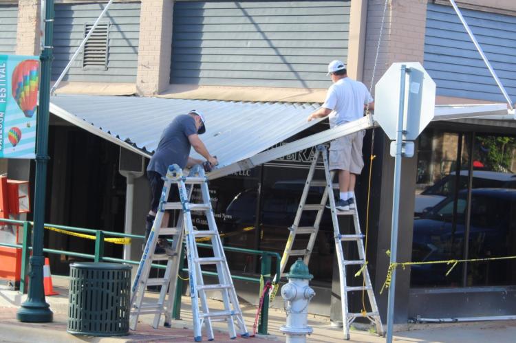 Repair work begins on awning