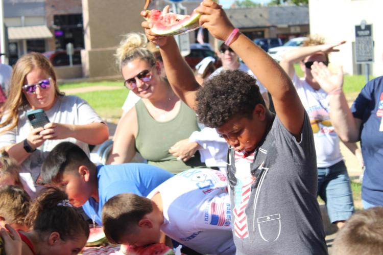 Above, winning the watermelon age 7-11 and under group, Will Smith, from Wills Point, who also won last year’s contest. Right, Joel Hansen was named the winner for the third time during the third annual Canton Hot Dog Eating contest.