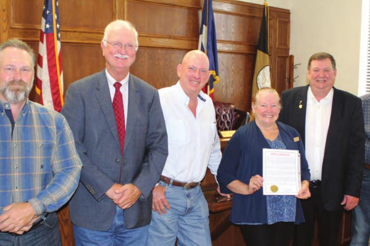 Carrie Woolverton of the Van Zandt County Historical Commission stood with the VZC Commissioners Court following unanimous approval by the court to recognize June 14 as Flag Day and the week of June 12 as Flag Week. Standing with Woolverton were left to right, VZC Pct. 1 Commissioner Chad LaPrade, VZC Pct. 2 Commissioner Virgil Melton Jr., VZC Pct. 3 Commissioner Keith Pearson, VZC Judge Don Kirkpatrick, and VZC Pct. 4 Commissioner Tim West. Photo by David Barber