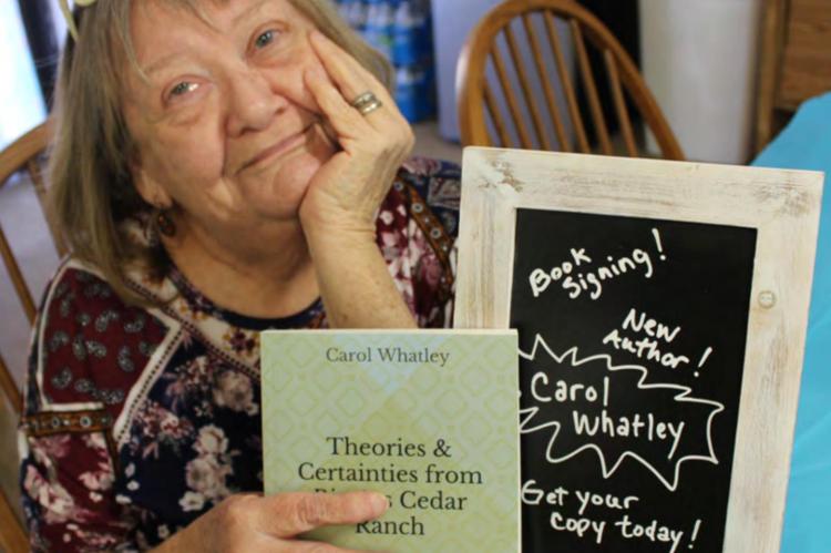 Carol with her newly published book in 2019. Photo by Britne Hammons