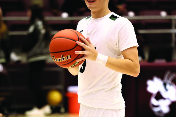 Rex Baldwin warms up prior to Canton’s game against Fairfield on Dec. 1. The Eagles would go on to take down Fairfield 54-33. Photo by Ethan Adams