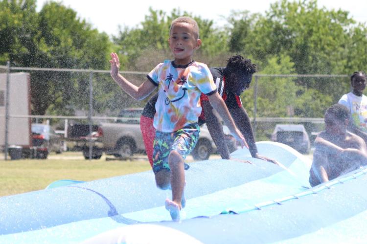Inflatable rides filled with water helped to keep kids cool during this year’s Juneteenth celebration event at South Park. Photo by David Kapitan