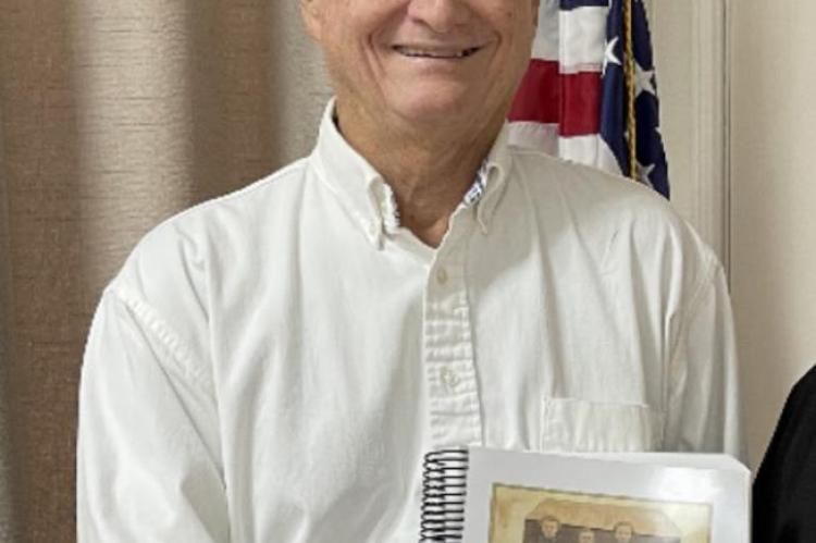 Larry Youngblood, speaker at the June 25 meeting and administrator of the Youngblood YDNA Project, with his book. Courtesy photo