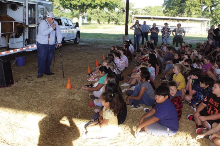 Van Zandt County Farm Bureau Board member Brian Cummins discussed the event activities with fourth grade students from Van Zandt County schools during the annual VZC Farm Bureau ‘Ag in the Classroom’ event Sept. 27 and 28 at the VZC Fairgrounds in Canton. Photos by David Barber