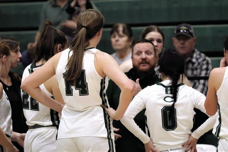 Head Coach Troy Carrell talks to his team during a timeout in Canton’s one-point victory over Mabank on Friday night. Photo by Lianna Reid