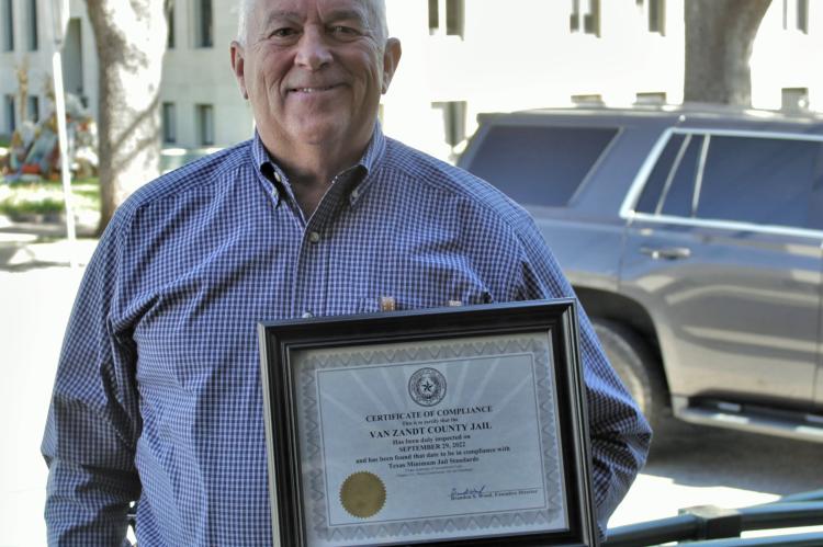 Van Zandt County Sheriff Joe Carter holds the ‘Certificate of Compliance’ recently awarded to the VZC Jail by the Texas Commission on Jail Standards. VZC Judge Don Kirkpatrick announced the accomplishment during the regular meeting of the VZC Commissioners Court Oct. 26. Photo by Ethan Adams