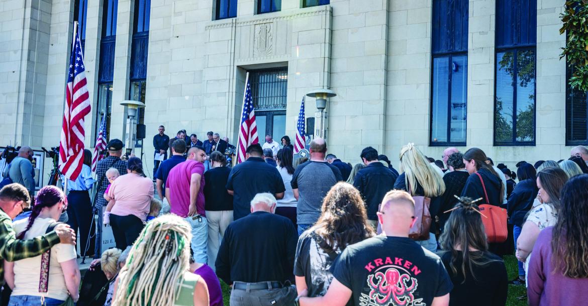 A number of individuals were in attendance for a prayer vigil held on the north side of the downtown square in Canton Oct. 21 to honor the memory of Deputy Adam Sherifi, who was killed in the line of duty serving a warrant Oct. 20 on State Highway 198. The prayer vigil was also held to remember the lives of a mother and four children that were lost Oct. 21 as a result of a structure fire. Photo by Melody Tarno-Thompson